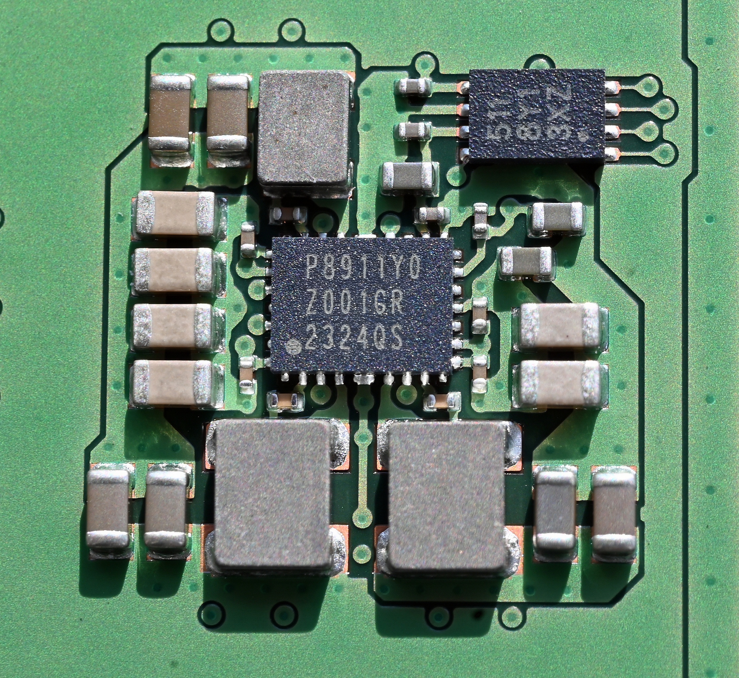 Figure 3 — A representative PMIC chip in QFN package — same package class as the AXP2101 (4×4 mm QFN-40, 0.4 mm pitch). The PicoCalc's U3 is the same general type, oriented near the cell connector on the carr…